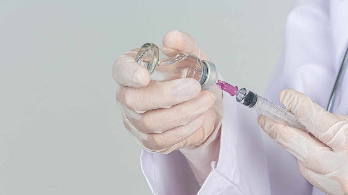 Doctor holding a vaccine bottle