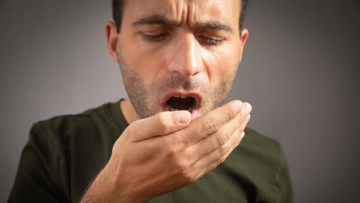 A man checking his breath