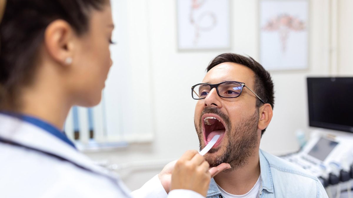 A doctor inspecting her patient's mouth