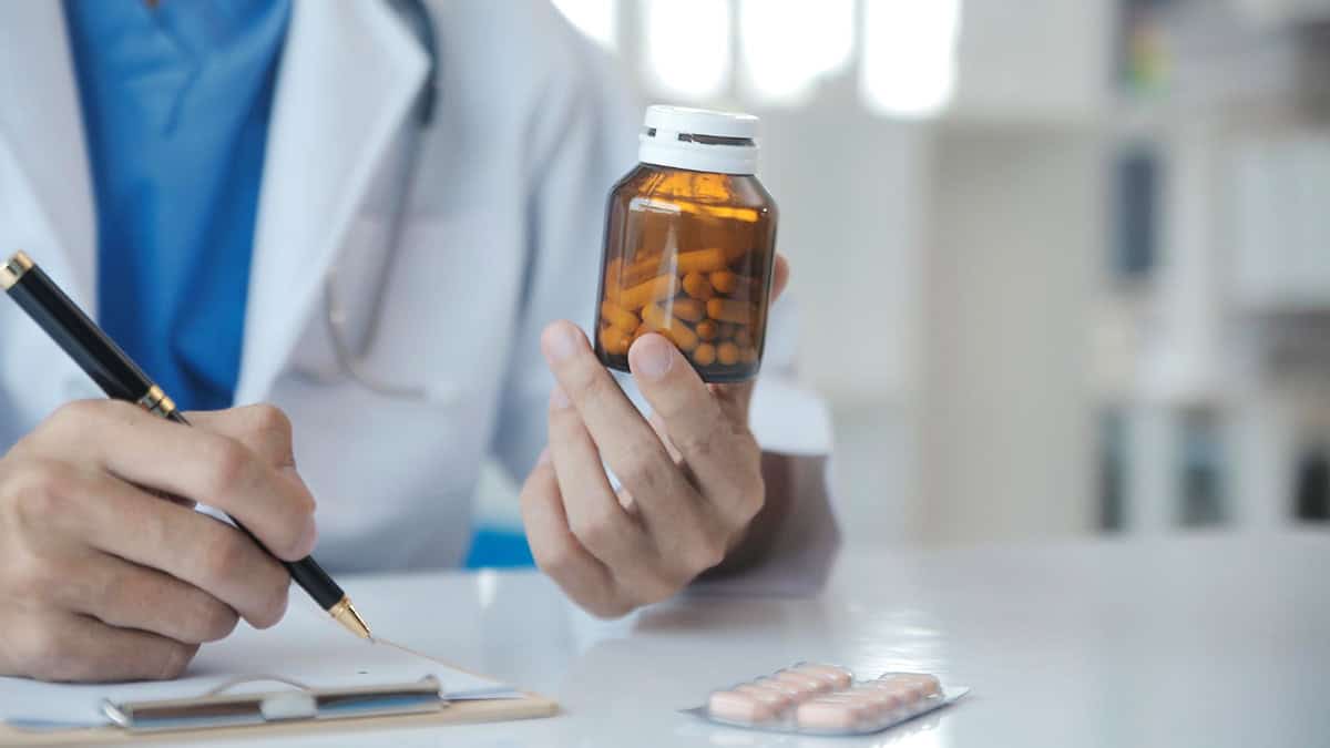 Doctor holding a medication bottle