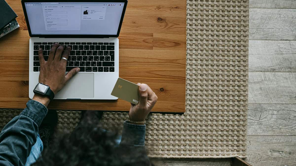 A person on a laptop typing his payment info