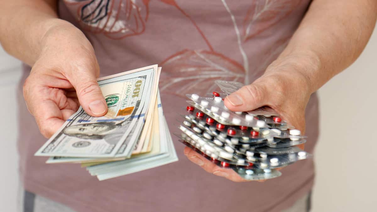 Women holding money and medication