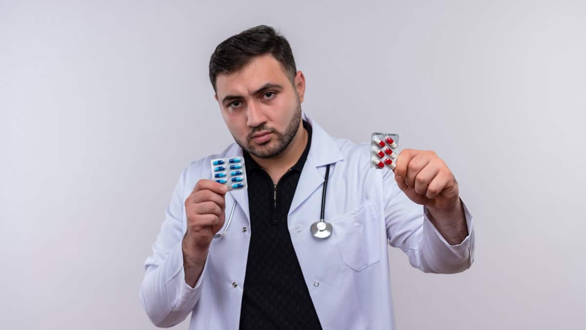 A doctor holding tablet packs