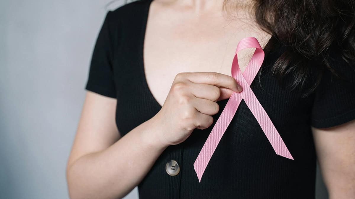 Women holding a pink ribbon